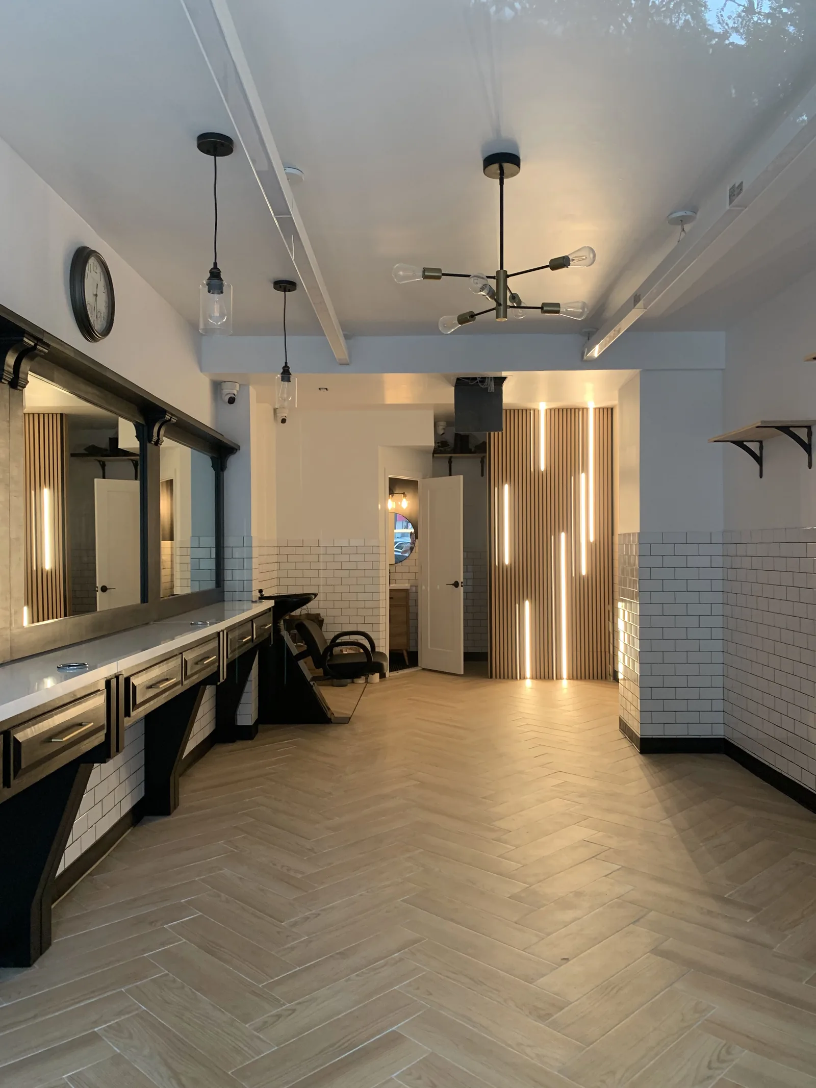 Completed Crown Royal Barbershop interior after drywall, tile, paint, lighting, and finish work