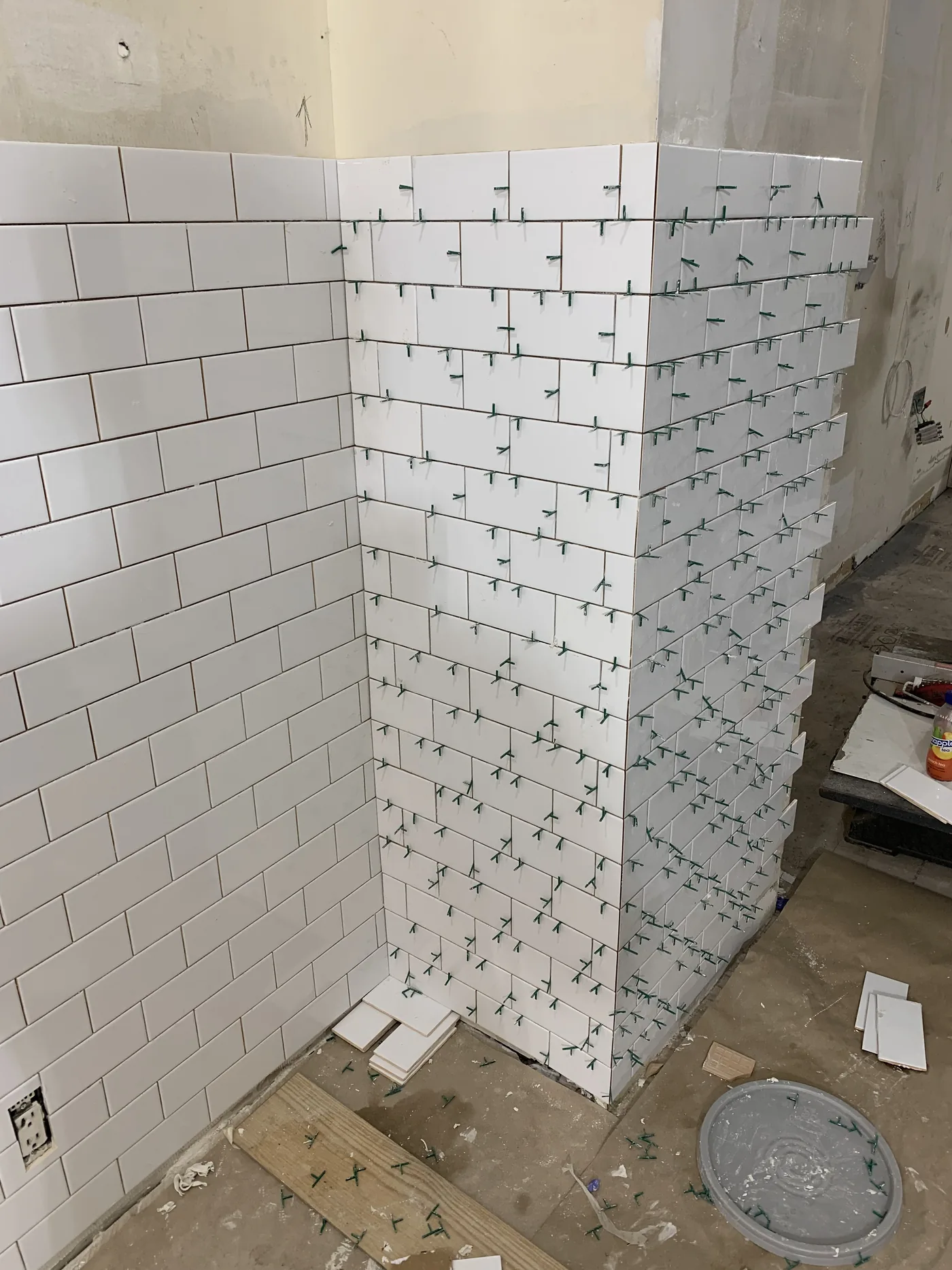 Subway tile installation in the main barbershop area