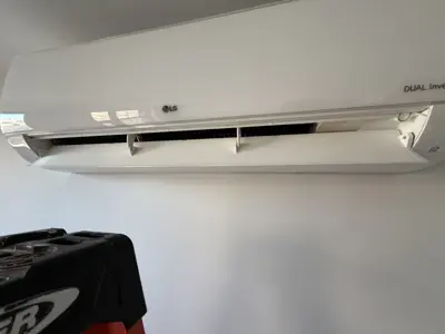 LG Dual Inverter mini-split AC unit mounted on a white wall after professional installation in NYC