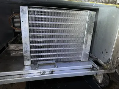 Clean AC condenser coil after professional maintenance service completed by NYC handyman team