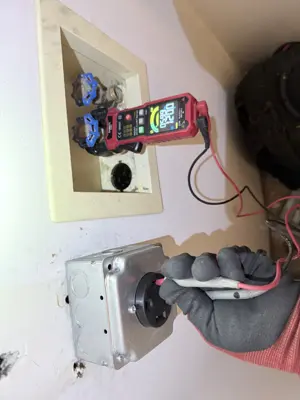 Technician testing water valve connections with a digital multimeter during plumbing repair in NYC