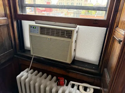 Window AC bracket and unit secured in NYC apartment window