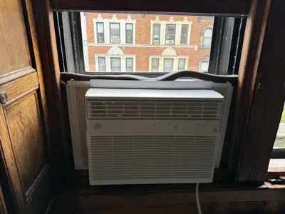 LG window AC unit installed with foam weather seal in Brooklyn