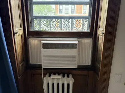 Window AC unit installed in top-sash position, NYC apartment