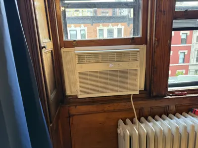 Midea window AC with support bracket in NYC co-op building