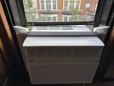 Window AC after installation — cooling output verified with IR thermometer