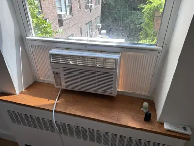 Window AC foam insulation panels installed to seal side gaps