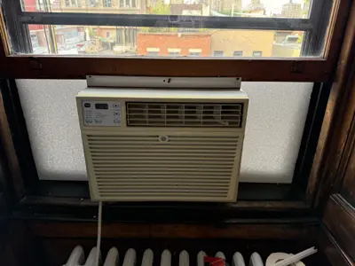Window AC installation at a NYC high-rise apartment