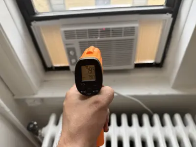 Custom plexiglass panel fitted around window AC unit