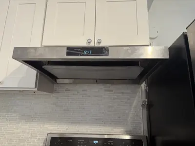 Microwave or range hood installation above stove