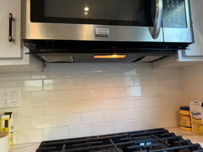 Microwave or range hood installation above stove