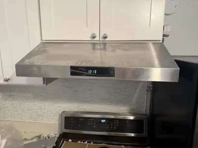 Microwave or range hood installation above stove
