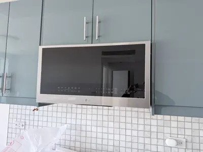 Microwave or range hood installation above stove