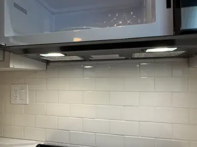 Microwave or range hood installation above stove