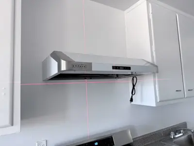 Range hood installation above kitchen stove