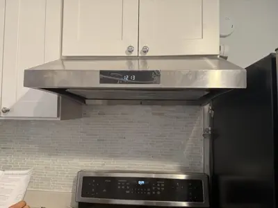 Microwave or range hood installation above stove