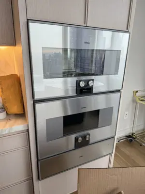 Luxury Gaggenau double wall oven installed in modern NYC kitchen cabinetry