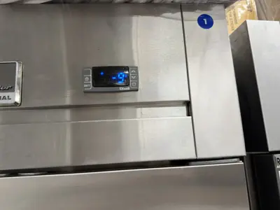 Commercial stainless steel refrigerator displaying working digital temperature control after repair in NYC