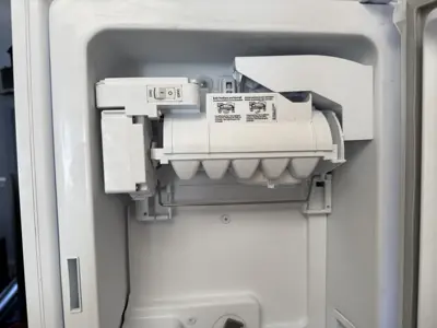 Close-up of refrigerator ice maker unit inspected and serviced by NYC handyman team