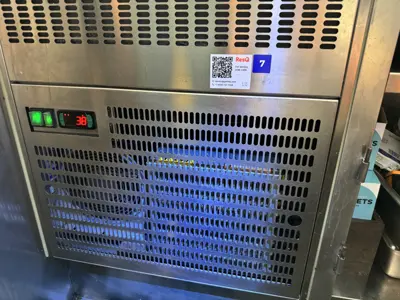 Commercial refrigeration unit displaying 38°F with green indicator lights after servicing by NYC handyman