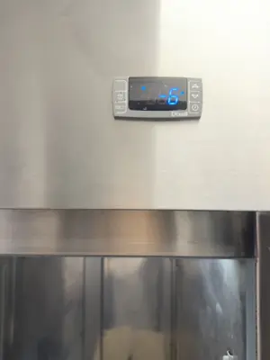 Commercial refrigerator digital temperature control panel displaying proper temperature after NYC appliance repair