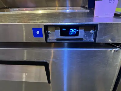 Commercial refrigerator digital display showing 38°F after appliance service in NYC