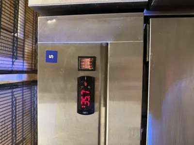 Commercial refrigerator digital temperature display reading 35.7°F after repair service in NYC
