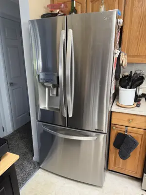 LG stainless steel French door refrigerator installed in NYC kitchen after appliance service