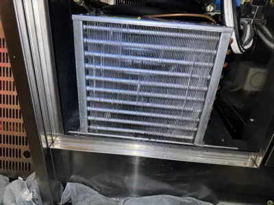 Clean commercial refrigerator condenser coils after professional servicing and maintenance in NYC