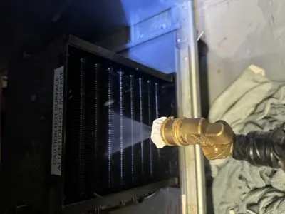 Water spray cleaning of commercial condenser coils during appliance maintenance service in NYC