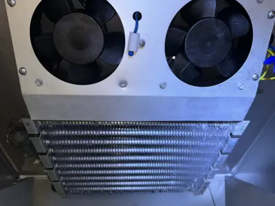 Cleaned dual evaporator fans and condenser coils inside commercial refrigerator after service by NYC handyman
