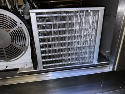 Clean condenser filter and fins on a commercial refrigeration unit after professional servicing by Repair ASAP LLC NYC