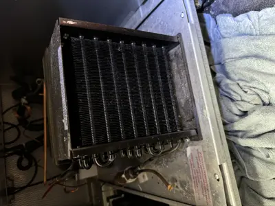 Clean commercial refrigerator condenser coils after professional deep cleaning service by NYC handyman