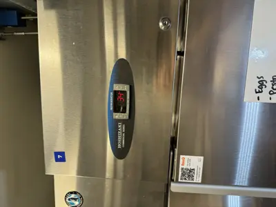 Hoshizaki commercial refrigerator displaying 34°F after successful repair and temperature calibration service in NYC