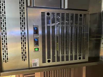Serviced commercial stainless steel refrigeration unit with digital controls operational after repair in NYC