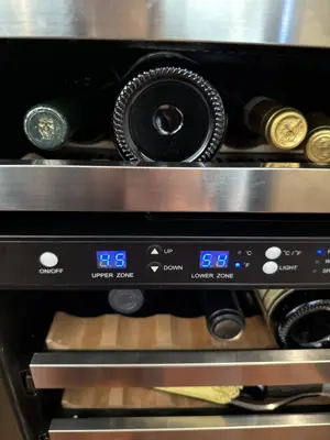 Dual-zone wine cooler with digital temperature display showing 85°F and 54°F zones after installation