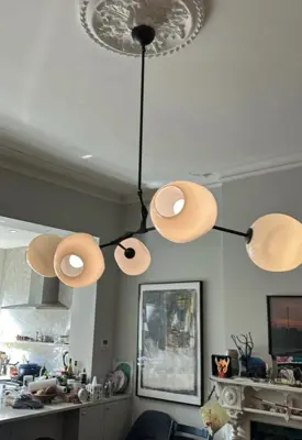 Chandelier installation — decorative light fixture hung and wired