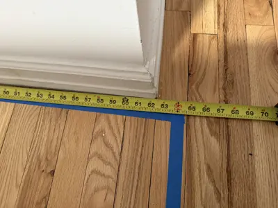 Baseboard installation along newly finished floor