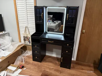 Fully assembled black vanity desk with LED mirror and gold hardware completed in NYC bedroom