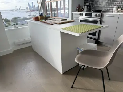 Assembled white IKEA kitchen island with Hudson River view in a modern NYC apartment