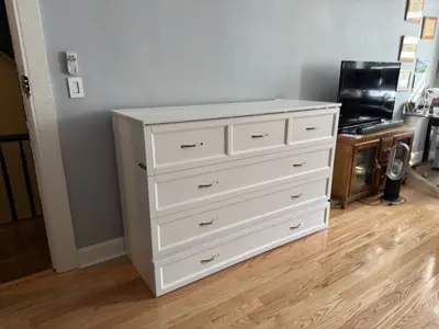 Completed Murphy bed installation with drawer storage in NYC bedroom