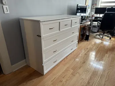 Fully assembled Murphy bed with built-in drawers in NYC bedroom
