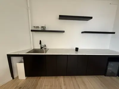 modern black kitchen cabinet and floating shelf assembly completed by repair asap llc in nyc