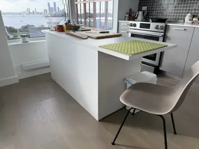 newly assembled white kitchen island with waterfront nyc skyline view in a modern apartment