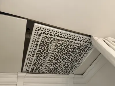 Decorative ventilation screen installed on ceiling for sprinkler system access
