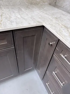 newly installed dark wood kitchen cabinets with marble countertop in nyc home