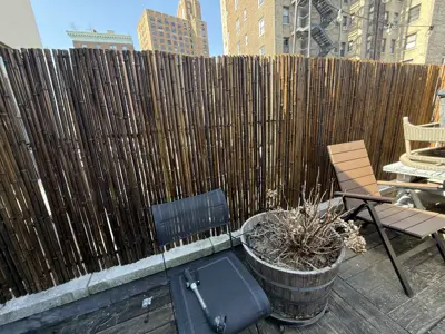 bamboo privacy fence installed on nyc rooftop terrace with city skyline in background