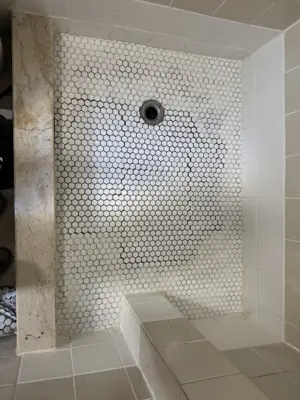 completed penny tile shower floor installation with center drain in nyc bathroom
