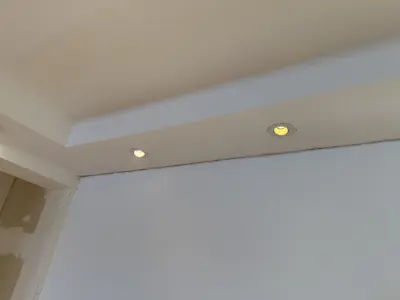 Newly installed recessed LED downlights in a tray ceiling soffit in a NYC apartment
