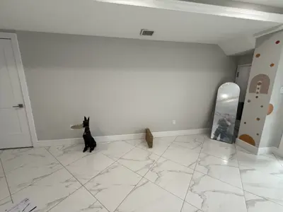 freshly painted light gray room with white trim and marble tile floor after professional interior painting